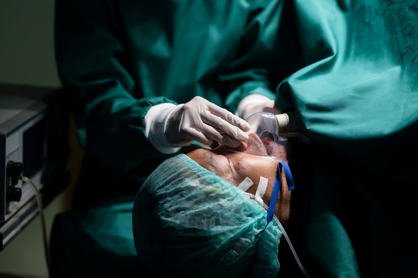Anesthesiologist wearing a mask to anesthetize the patient for surgery.